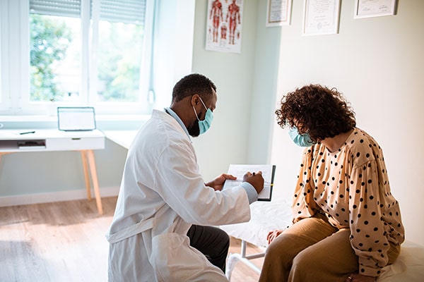 Male doctor explaining paperwork to a female patient