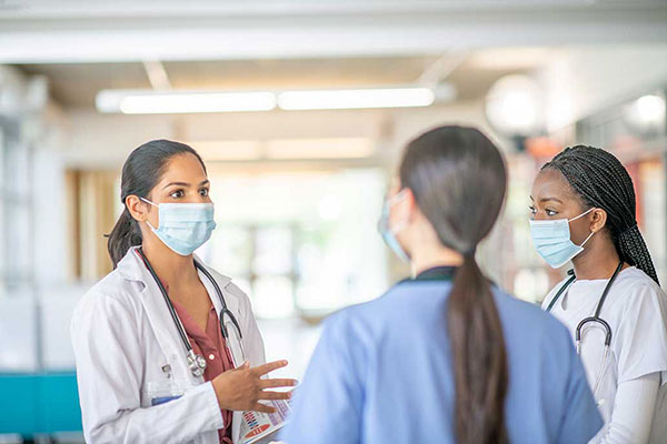 Three health care workers talking