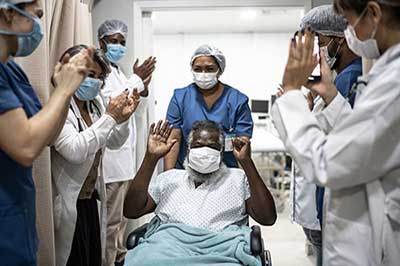 Hospital staff cheering a patient's discharge